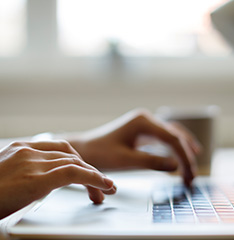 two hand typing in a laptop